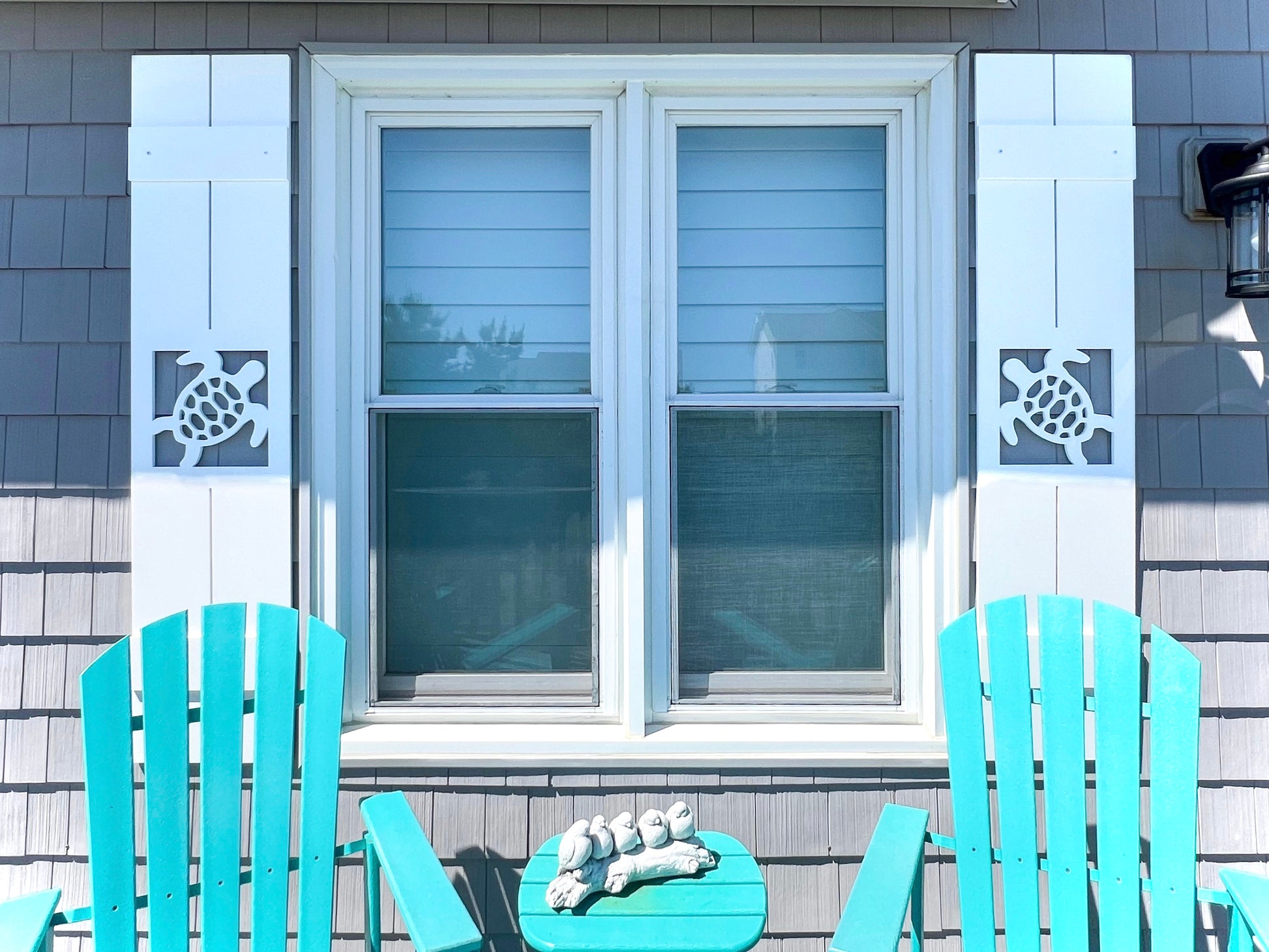 Sea Turtle Shutters. Exterior board and batten style coastal window shutters with sea turtle cutout. Weatherproof PVC beach house shutters for outdoor decor.