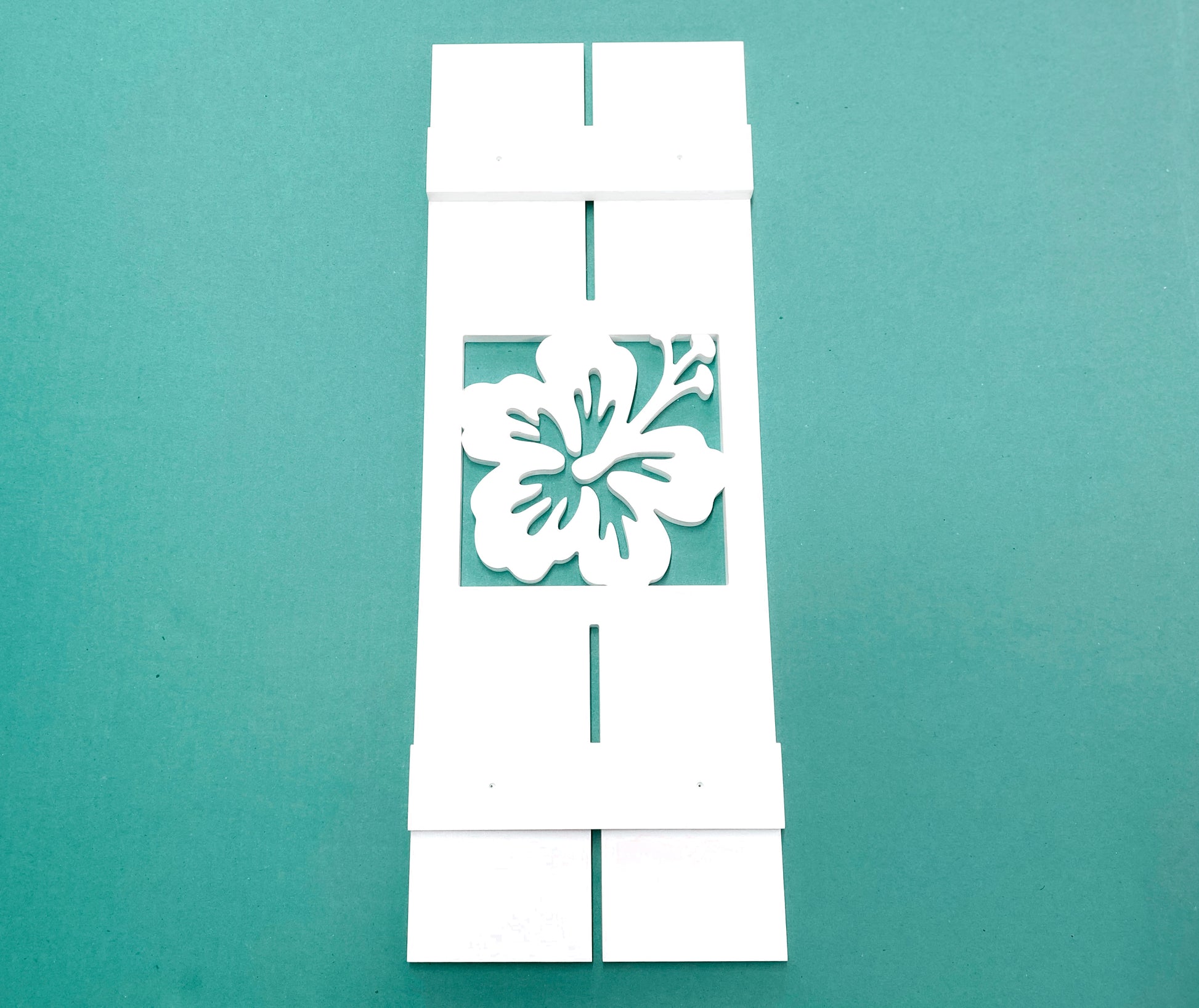 Exterior board and batten style coastal window shutters with tropical hibiscus flower cutout. Weatherproof PVC beach house shutters for outdoor decor.