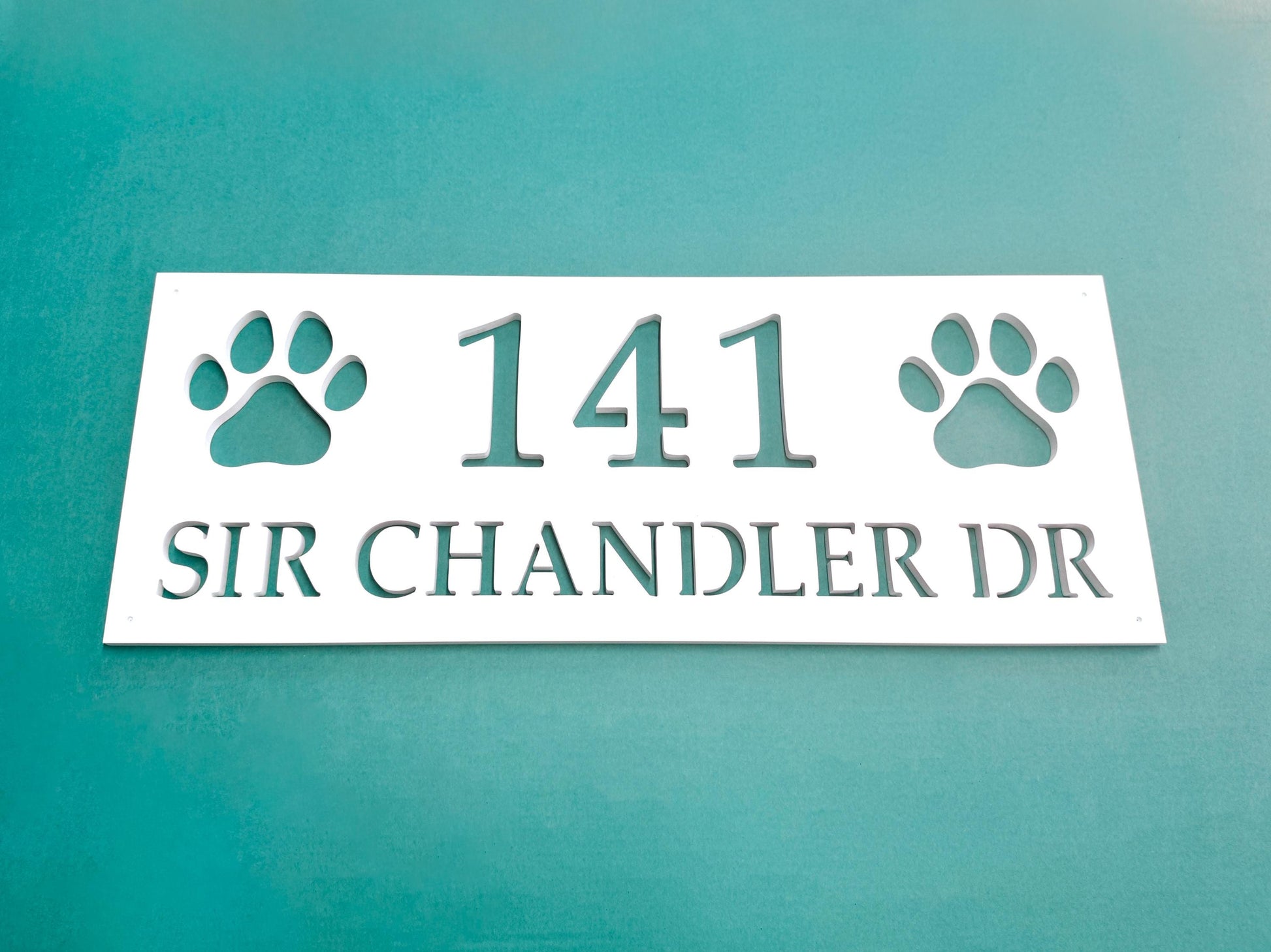Weatherproof PVC address sign with street name and house numbers, with 2 dog paws for decoration.